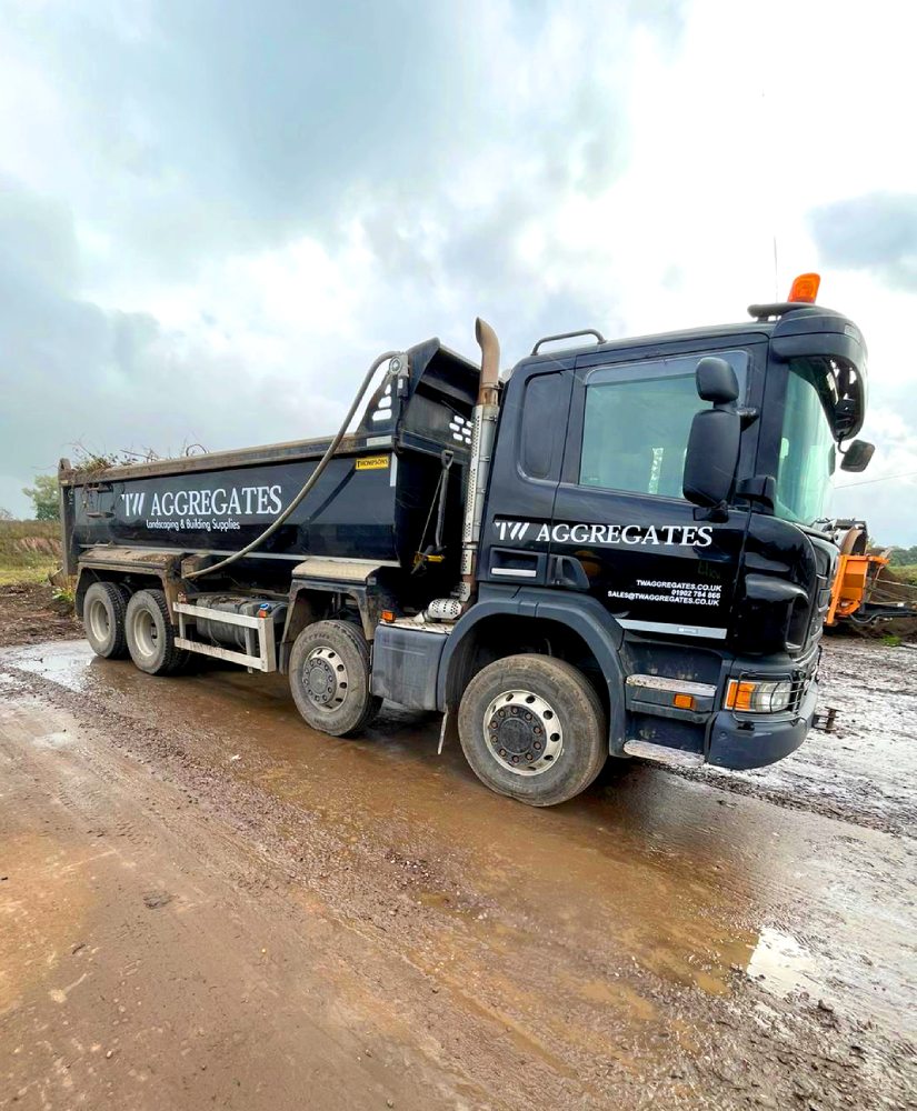 TW Aggregates delivery vehicle carrying landscaping materials